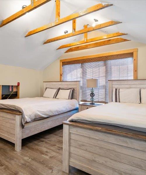 bedroom featuring lofted ceiling and wood finished floors