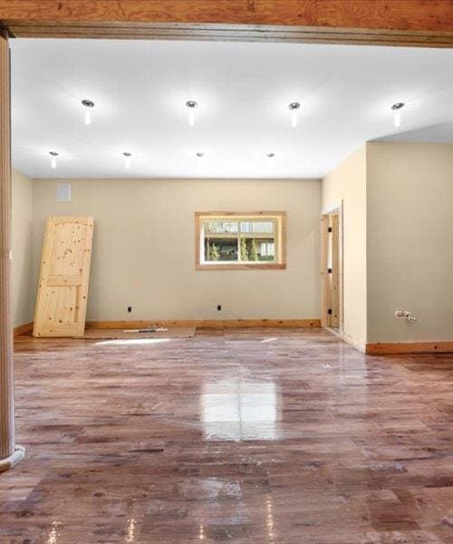 unfurnished room featuring baseboards and wood finished floors
