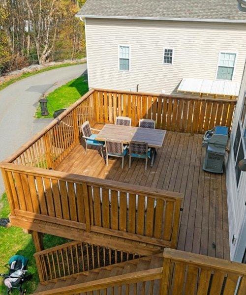 wooden deck featuring outdoor dining area
