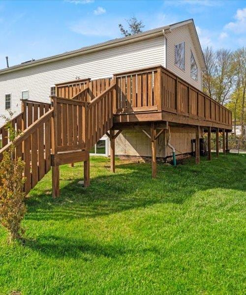 back of property with a yard and a deck