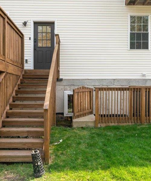 entrance to property with a lawn