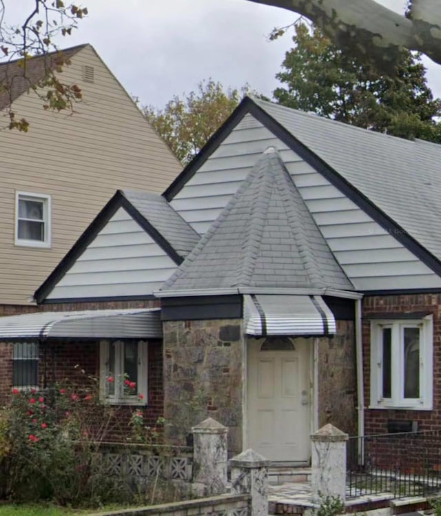 view of front of house with stone siding and brick siding