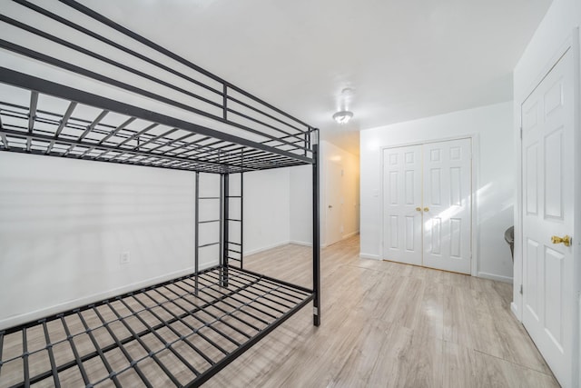 unfurnished bedroom with baseboards and wood finished floors