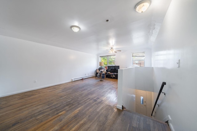living room featuring a ceiling fan, baseboards, wood finished floors, and baseboard heating