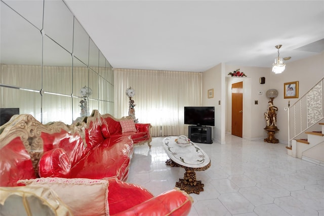 living room with tile patterned floors, stairway, and baseboards