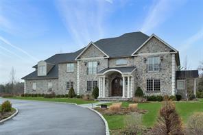 2 Enclave Ct, Dix Hills, NY 11746 - traditional-style home featuring stone siding and curved driveway