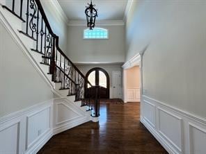 2 Enclave Ct, Dix Hills, NY 11746 - foyer featuring a decorative wall, stairway, ornamental molding, a chandelier, and wainscoting