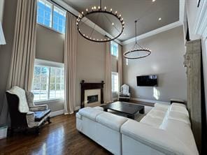 2 Enclave Ct, Dix Hills, NY 11746 - living area featuring a fireplace, plenty of natural light, wood finished floors, baseboards, and ornamental molding