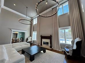 2 Enclave Ct, Dix Hills, NY 11746 - living room with a high ceiling, a fireplace, and wood finished floors