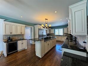 2 Enclave Ct, Dix Hills, NY 11746 - kitchen featuring dark countertops, a center island, a chandelier, dark wood finished floors, and recessed lighting