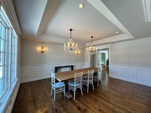 2 Enclave Ct, Dix Hills, NY 11746 - dining space featuring a decorative wall, a raised ceiling, a chandelier, dark wood-style flooring, and wainscoting