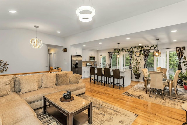 1 Valley Forge Dr, Wheatley Heights, NY 11798 - living room with a chandelier, light wood-style flooring, recessed lighting, and lofted ceiling