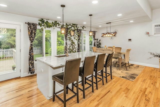 1 Valley Forge Dr, Wheatley Heights, NY 11798 - dining area with healthy amount of natural light, recessed lighting, light wood-style flooring, and baseboards