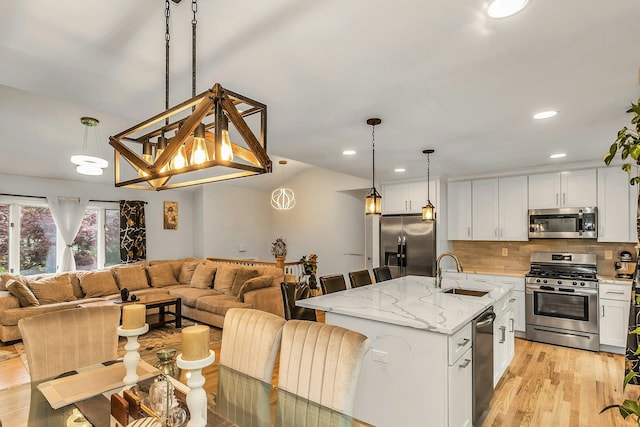 1 Valley Forge Dr, Wheatley Heights, NY 11798 - kitchen featuring stainless steel appliances, a sink, open floor plan, decorative backsplash, and recessed lighting