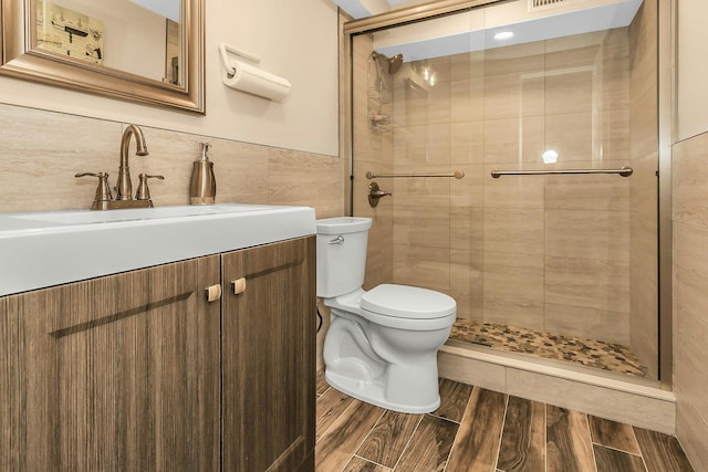 1 Valley Forge Dr, Wheatley Heights, NY 11798 - bathroom with tile walls, toilet, a stall shower, wood finished floors, and vanity
