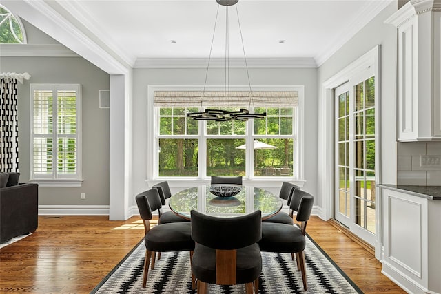 1608 Stewart Ln, Laurel Hollow, NY 11791 - dining space featuring a chandelier, light wood finished floors, and ornamental molding