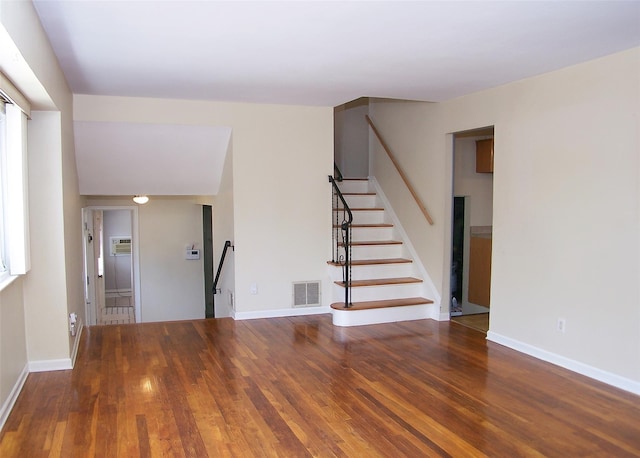 interior space featuring visible vents, wood finished floors, and baseboards
