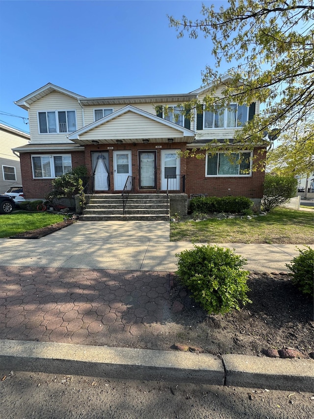 view of front of home featuring brick siding
