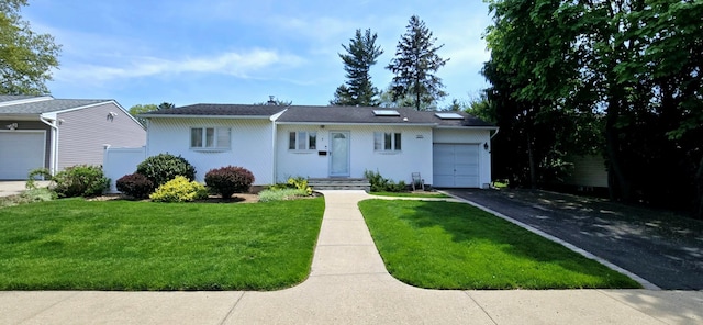 ranch-style home with a front yard, aphalt driveway, and a garage