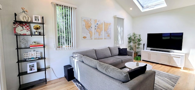 living room featuring recessed lighting, lofted ceiling with skylight, and light wood-style floors