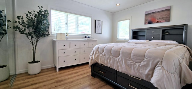 bedroom featuring baseboards, recessed lighting, light wood-style flooring, and crown molding