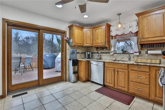 kitchen with brown cabinetry, visible vents, dishwasher, ceiling fan, and backsplash