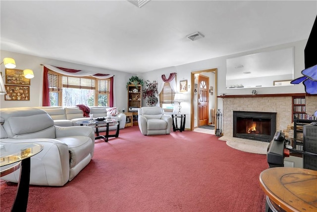 living room with carpet flooring, visible vents, and a fireplace