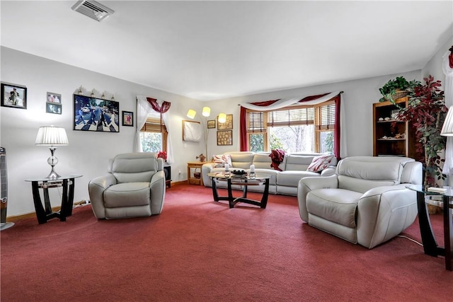 living room featuring a wealth of natural light, visible vents, and carpet floors