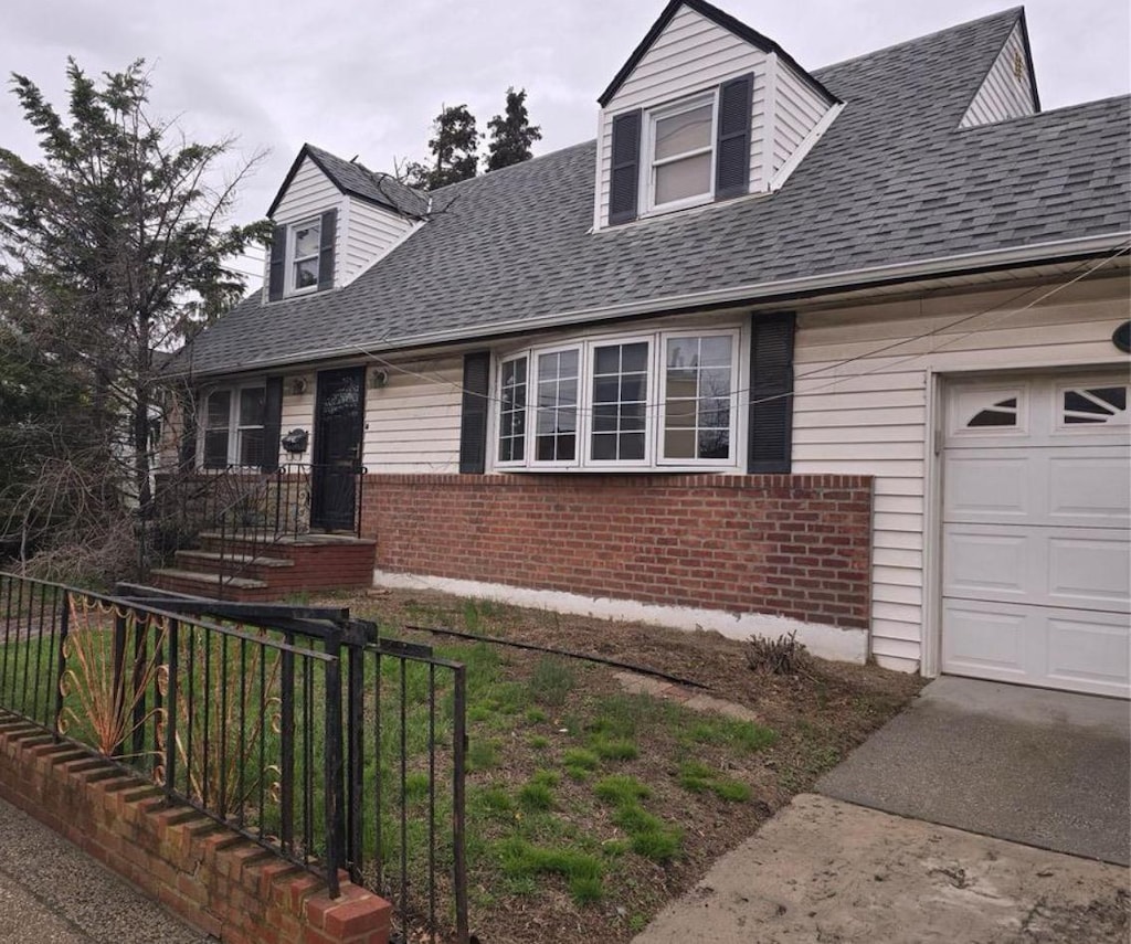 new england style home featuring brick siding, fence, and roof with shingles