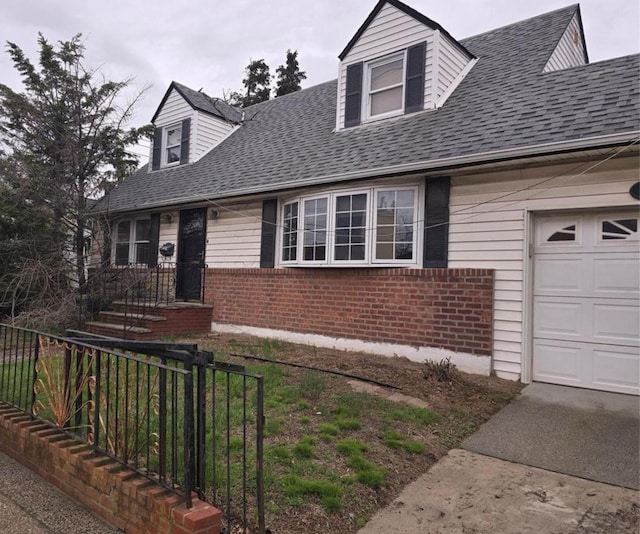 new england style home featuring brick siding, fence, and roof with shingles