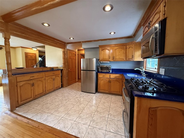163 E Hawthorne Ave, Valley Stream, NY 11580 - kitchen featuring stainless steel appliances, crown molding, brown cabinetry, a sink, and recessed lighting