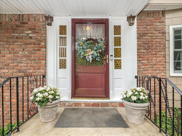 view of exterior entry with brick siding