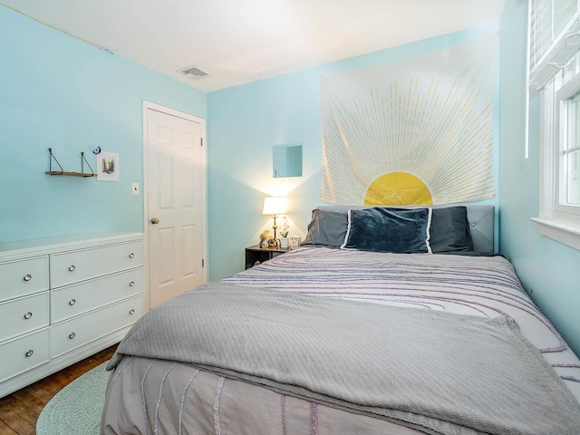 bedroom with visible vents and wood finished floors