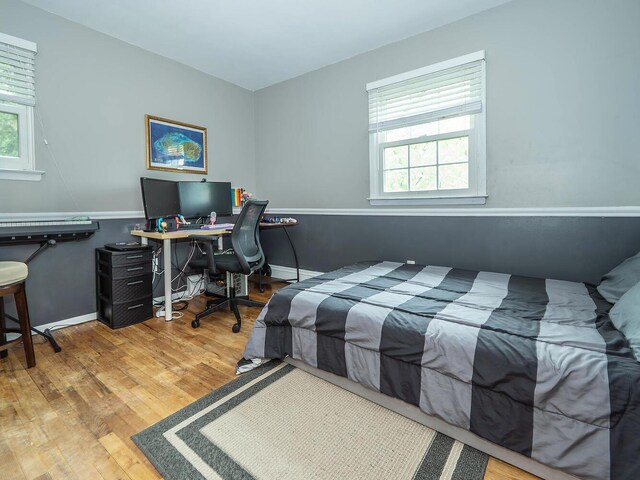 bedroom featuring a baseboard radiator and wood finished floors