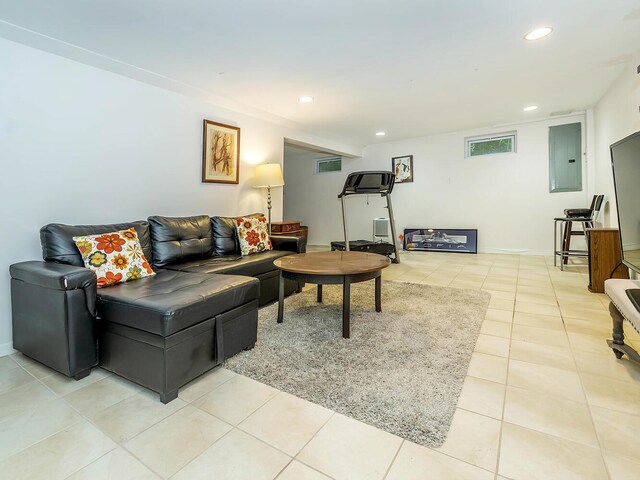 living area featuring baseboards, light tile patterned flooring, recessed lighting, and electric panel