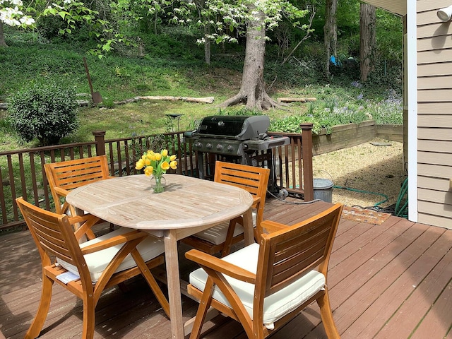 deck with area for grilling and outdoor dining area