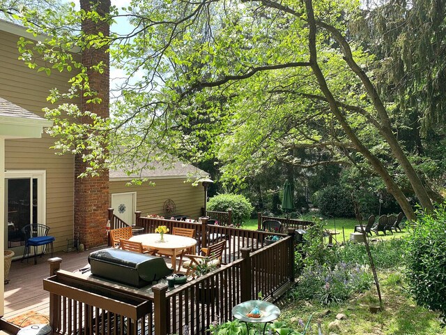 wooden deck featuring outdoor dining space and grilling area