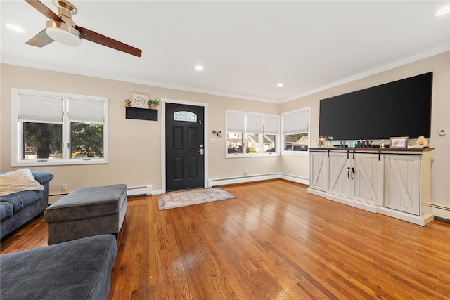 living room featuring crown molding, a ceiling fan, a baseboard radiator, and a baseboard heating unit