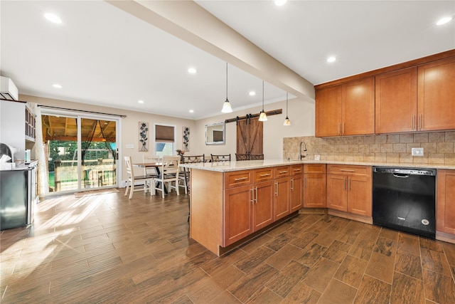 kitchen with a peninsula, brown cabinets, a barn door, dishwasher, and decorative backsplash
