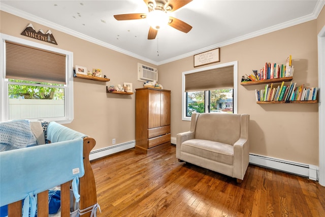 living area with a baseboard heating unit, hardwood / wood-style floors, ornamental molding, and a wall mounted AC