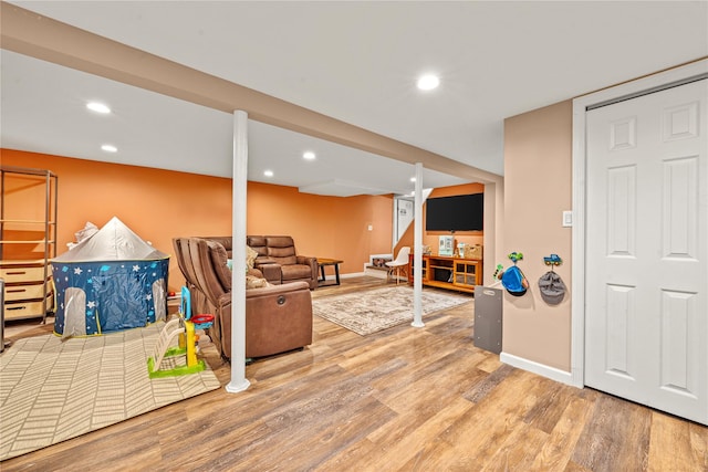 living area with stairway, recessed lighting, baseboards, and wood finished floors