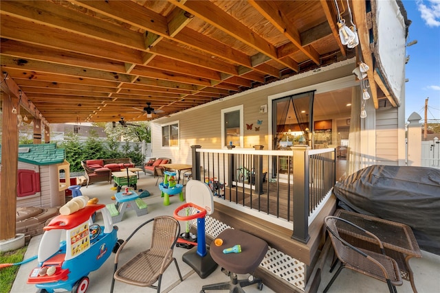 wooden deck with outdoor lounge area and a patio area
