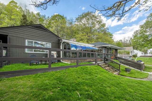 119 W Hunns Lake Rd, Stanfordville, NY 12581 - back of property with a sunroom, a lawn, and a chimney