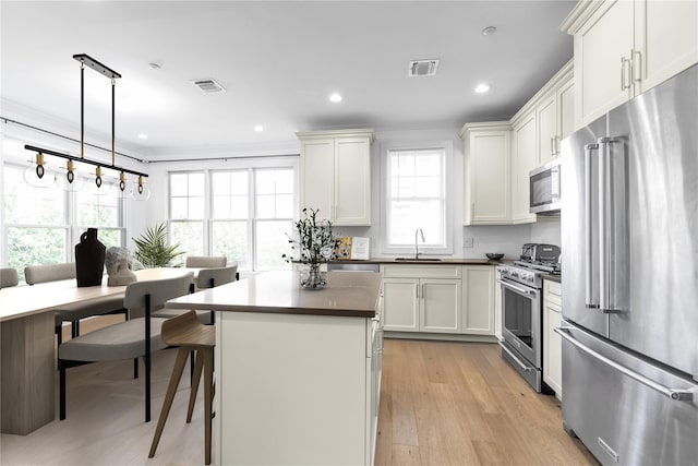 17101 Aspenwood Dr, Plainview, NY 11803 - kitchen with high end appliances, healthy amount of natural light, a sink, a kitchen island, and recessed lighting