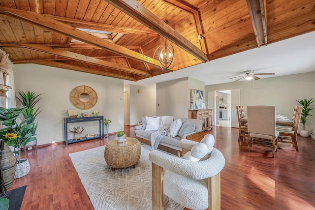 living room featuring vaulted ceiling with beams, ceiling fan with notable chandelier, wooden ceiling, and wood finished floors