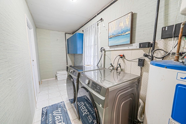 laundry area with light tile patterned floors, wallpapered walls, laundry area, water heater, and washer and clothes dryer