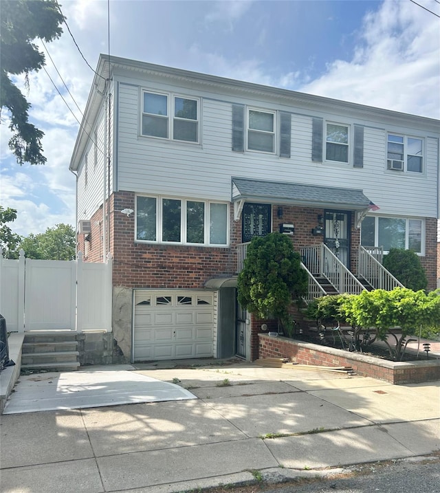 21-12 144th St, Whitestone, NY 11357 - view of front of home featuring an attached garage, brick siding, driveway, and fence
