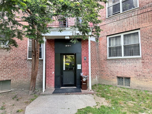property entrance featuring brick siding