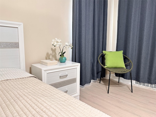 bedroom featuring light wood finished floors and visible vents