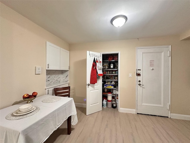 dining room with light wood-style floors and baseboards